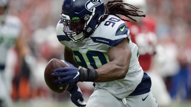 Seattle Seahawks outside linebacker Jadeveon Clowney (90) returns an interception for a touchdown against the Arizona Cardinals during the first half at State Farm Stadium.
